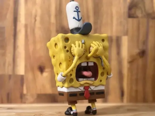 spongebob crying next to a picture