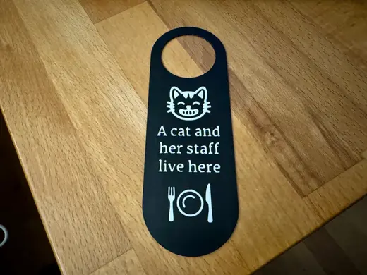 Door Hanger: A cat and her staff live here