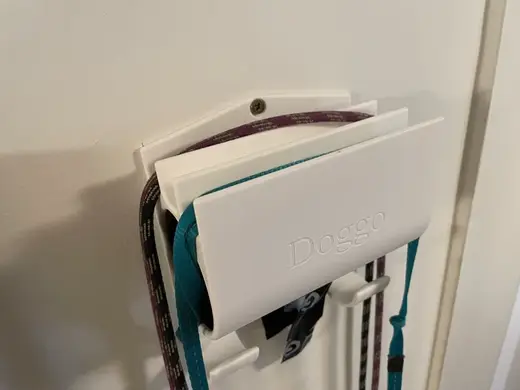 Dog leash hanger and poop bag dispenser