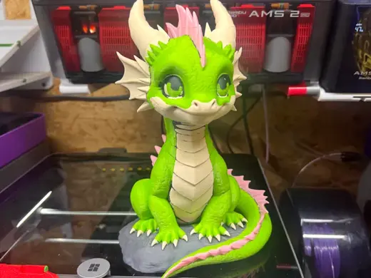 baby dragon sitting on rock