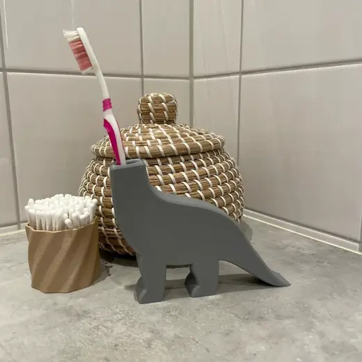 Dinosaur toothbrush holder