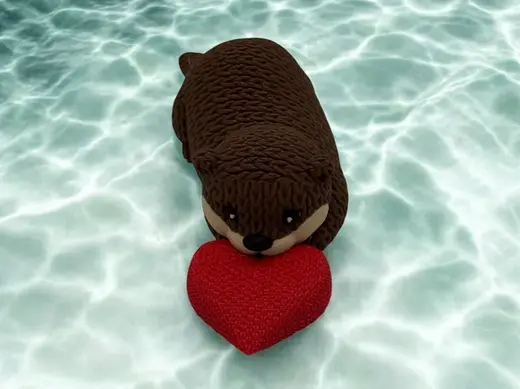 Cute lying Knitted Otter with optional Heart