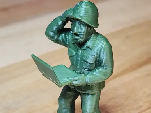Green Toy US Army Soldier holding Laptop Computer