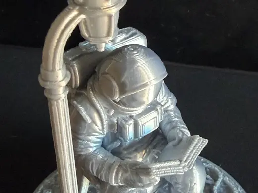 Diorama Astronauta leyendo libro bajo una farola