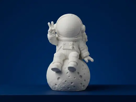 Astronaut Sitting on Moon Figurine