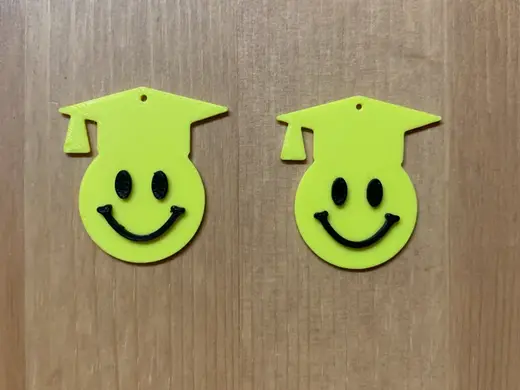 graduation emoji earrings