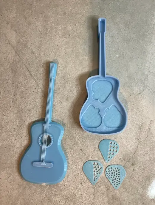 Guitar Shaped storage box with strings and plecs