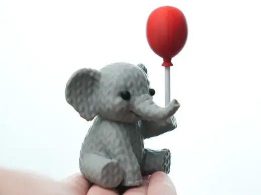 Knitted Elephant holding balloon