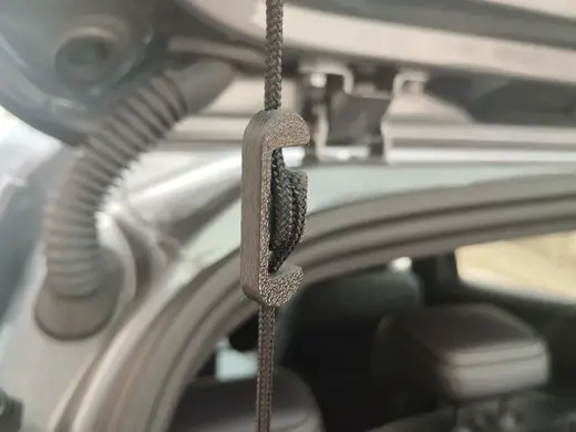 Parcel shelf cord tensioner