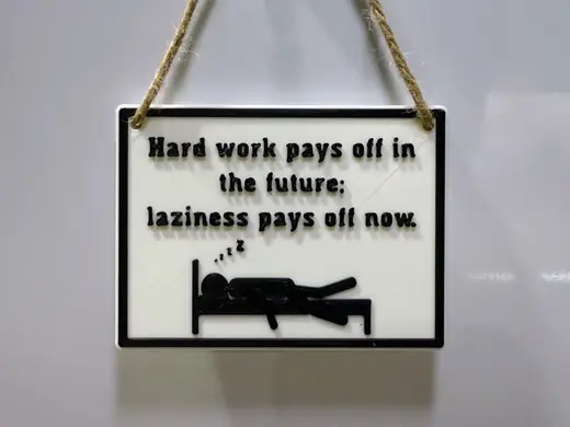 "Laziness pays off now" sign/plaque