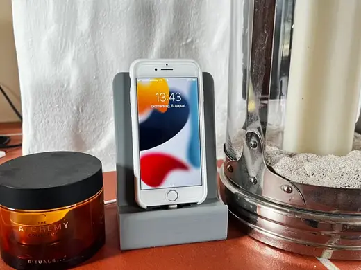 Phone-stand with holes for a charging cable