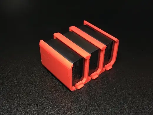 Sony NP-FW50 battery holder with thumb tab